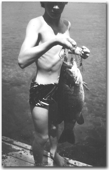 Little son, Eric, holds big bass he caught.