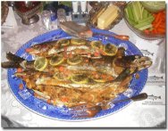 A plate fit for a king!  Baked stuffed Lake Trout and land locked salmon from lake Winni!  I prepare such a dish for my best guests and also once a year for our annual Christmas party. Here's how: Rub the fish (with head on as such a noble fish does not deserve to be decapitated!) with olive oil and lemon juice. Salt it inside and out. Sprinkle it with Corn Flake crumbs. Stuff with Pepperidge Farm stuffing, following the directions on the package. Bake a 4 pound fish on a greased baking dish for about 40 minutes at 375 degrees. Remove from oven and sprinkle trout (not salmon as it's delicate flavor will be eclipsed by the cheese) grated cheese with slivered almonds. Bake for another 5 minutes until almonds are brown. Remove from oven and serve with wild rice and a green veggie, washed down by a nice dry white wine!