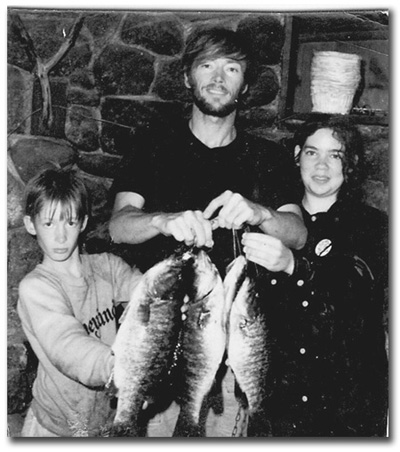 Eric and Rita in 1970 with father, holding small mouth bass.