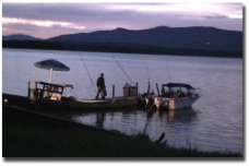 The author heads out to his boat on Bear Island at sunrise for some salmon trolling -- the most peaceful time of the day, before the high performance boats start screaming all over the lake…and the time the plankton, which do not like the light, are high near the surface followed by the smelt who eat the plankton,…followed by the salmon who eat the smelt…followed by me who eats the salmon!