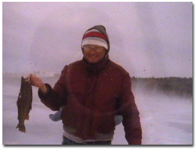 The late Paul Phillippe with a rainbow trout caught through the ice.