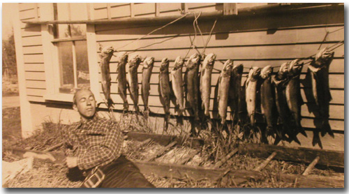 Uncle Gordon Hines, cooling it, with a big string of lake trout.