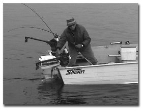 Ted St. Onge lowering his down rigger ball with Davis spinners attached and his live sewn shiner just above and behind it to 44 degrees where the salmon are and where he will soon catch one.