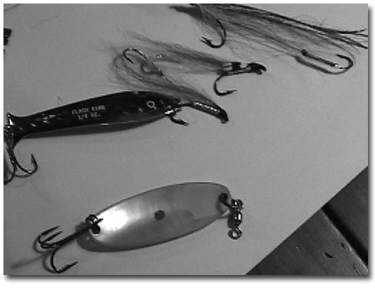 Chuck French's favorite lures: Antique Pearl Wobbler, Red & White Streamers, and blue Flash King.