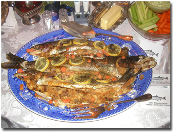 A plate fit for a king! Baked stuffed Lake Trout and land locked salmon from lake Winni! I prepare such a dish for my best guests and also once a year for our annual Christmas party. Here's how: Rub the fish (with head on as such a noble fish does not deserve to be decapitated!) with olive oil and lemon juice. Salt it inside and out. Sprinkle it with Corn Flake crumbs. Stuff with Pepperidge Farm stuffing, following the directions on the package. Bake a 4 pound fish on a greased baking dish for about 40 minutes at 375 degrees. Remove from oven and sprinkle trout (not salmon as it's delicate flavor will be eclipsed by the cheese) grated cheese with slivered almonds. Bake for another 5 minutes until almonds are brown. Remove from oven and serve with wild rice and a green veggie, washed down by a nice dry white wine!