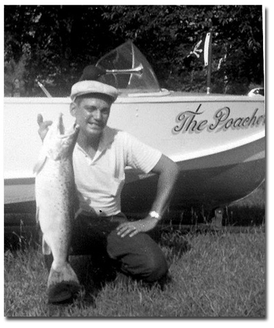 A photo of Ted St. Onge with a 31" 10lbs salmon in front of his boat, "The Poacher."