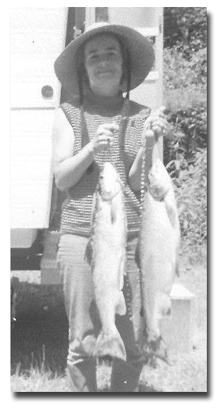 Photo of wife Pauline St. Onge holding two fish.