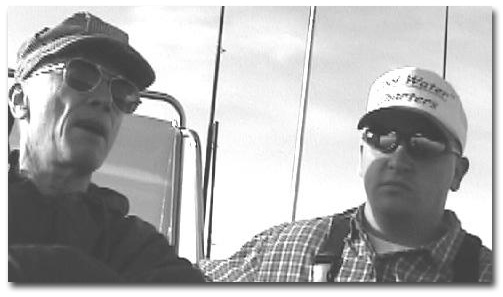 Travis Williams on the right and the author on the left in Travis' slick boat, "Cool Waters" on their way to a good salmon fishing ground.